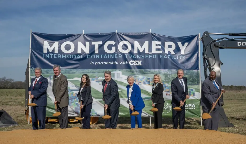 Eight people with spades, breaking ground at the Montgomery Intermodal Container Transfer Facility at the Port of Alabama