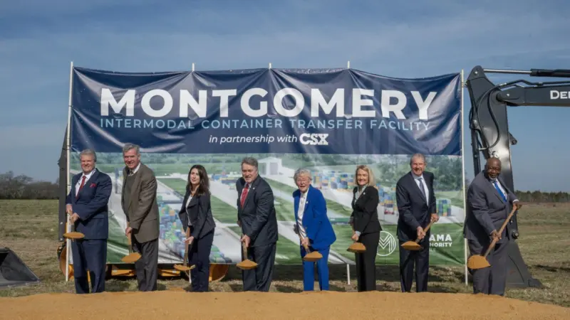 Eight people with spades, breaking ground at the Montgomery Intermodal Container Transfer Facility at the Port of Alabama