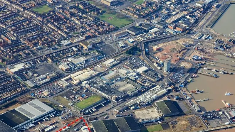 An aerial shot of the Port of Grimsby showing the Grimsby Seafood Village outlined in red in the bottom left