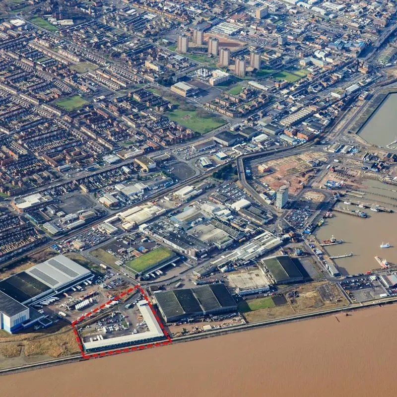 An aerial shot of the Port of Grimsby showing the Grimsby Seafood Village outlined in red in the bottom left