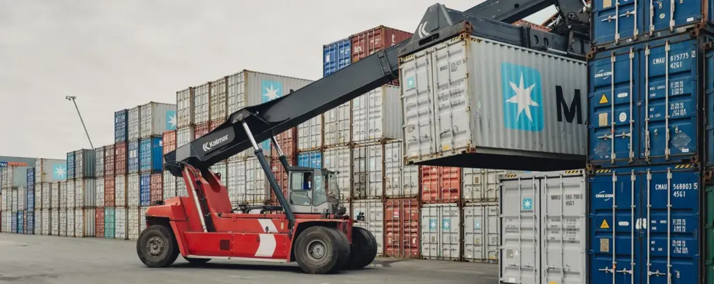 Kalmar forklift lifting a Maersk container