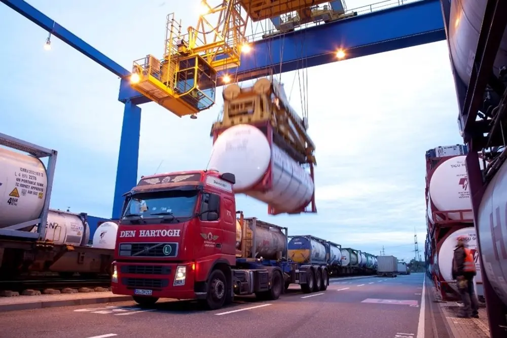 A truck being loaded with freight from a crane