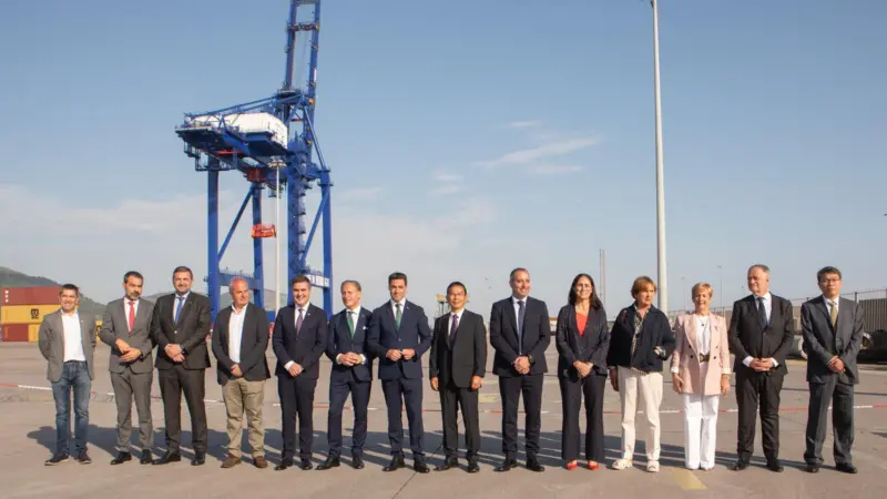 ship-to-shore crane at the Port of BIlbao with port authority and company employees standing in front