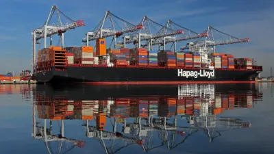Hapag-Lloyd container ship at the Port of Southampton with five ship-to-shore cranes in the background