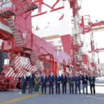 Representatives from BEST standing in front of a new ship-to-shore cranes at the Port of Barcelona