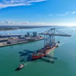 Port of Southampton from the air showing quay cranes arriving